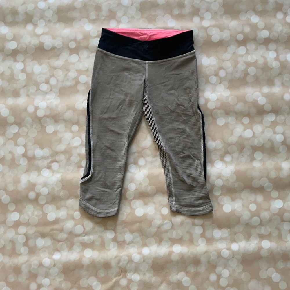 Adorable black and white striped capris with pink accents and cute side detail.